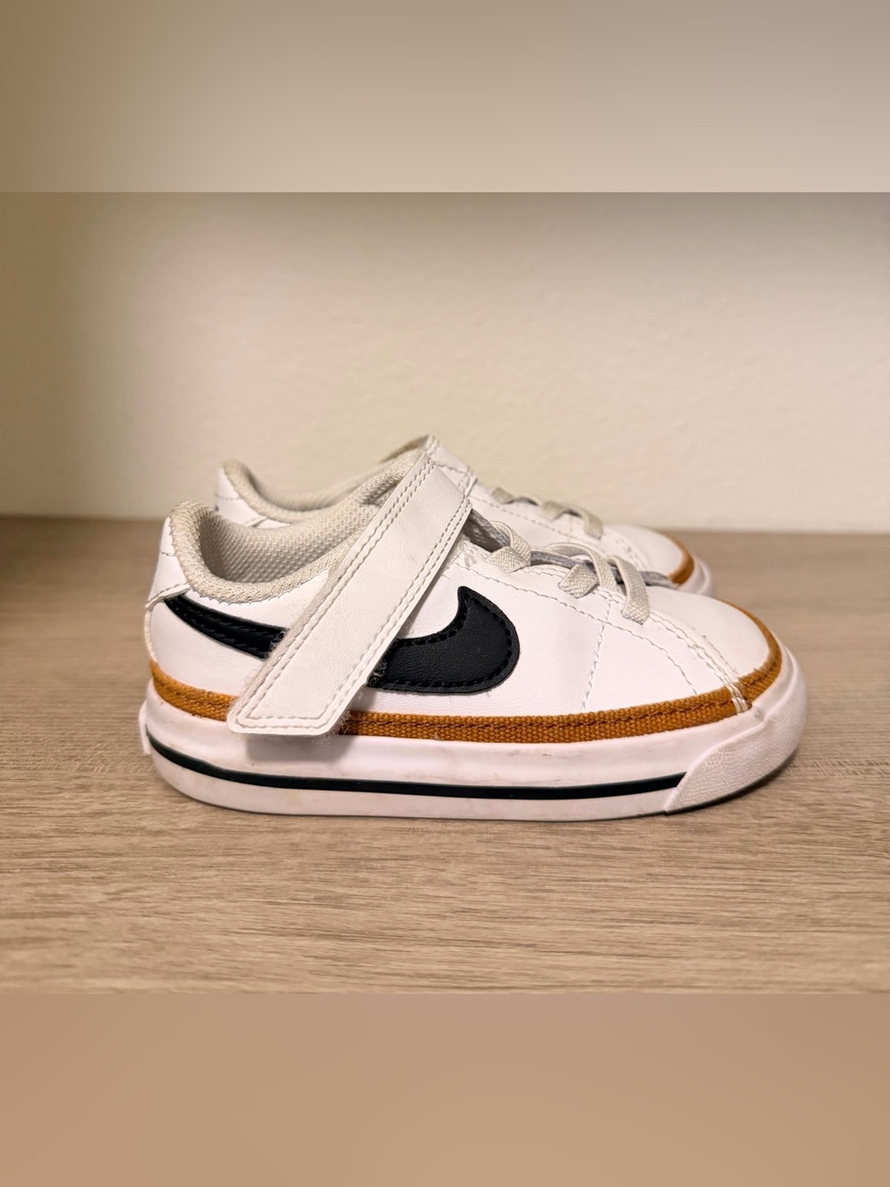 Nike Kids White Sneakers with Black Swoosh and Brown Accent